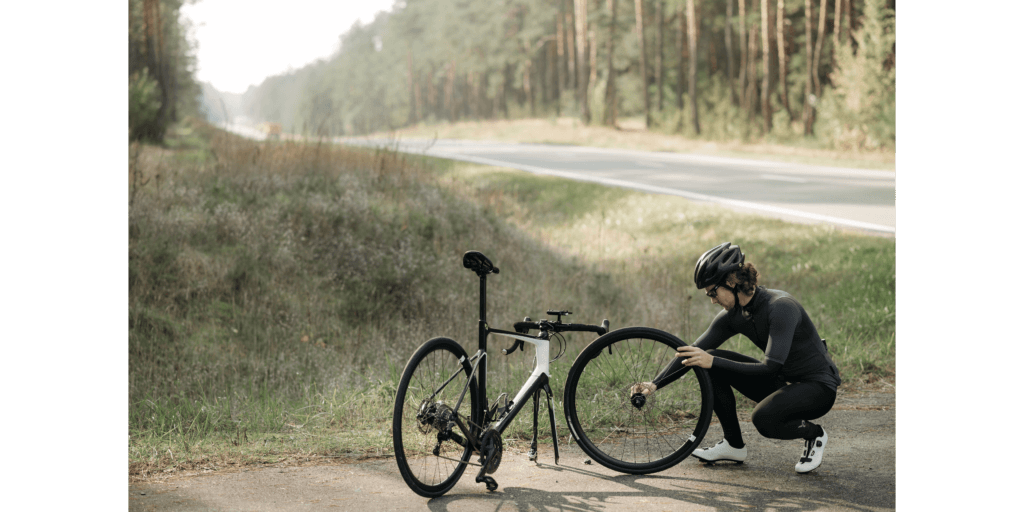 a cyclist fixing a puncture on his bike