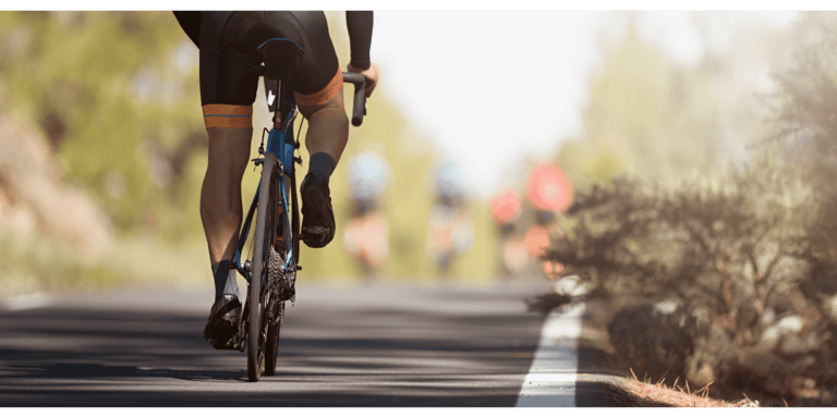 the lower half of a male cyclist wearing cycling shorts