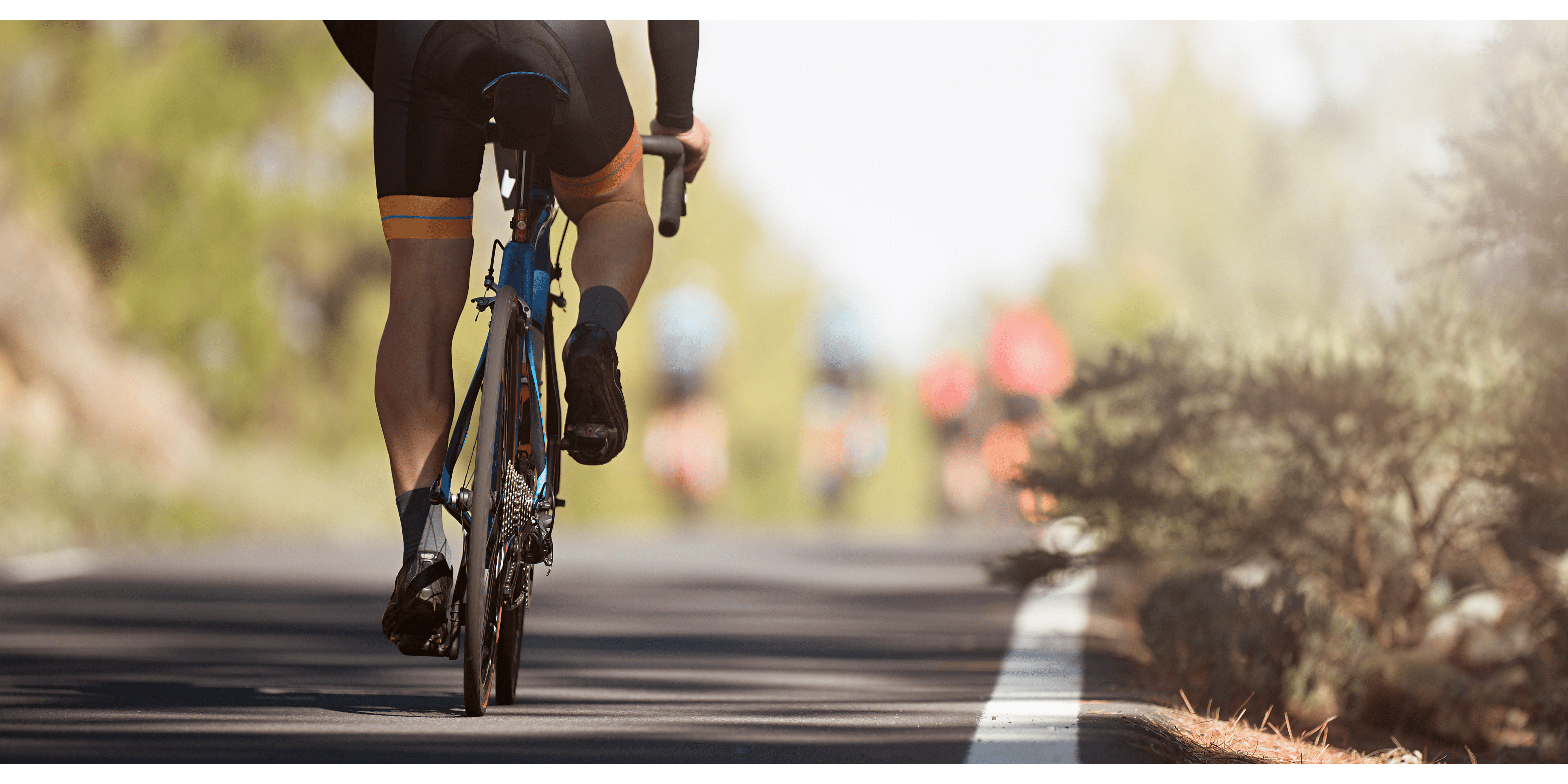 the lower half of a male cyclist wearing cycling shorts