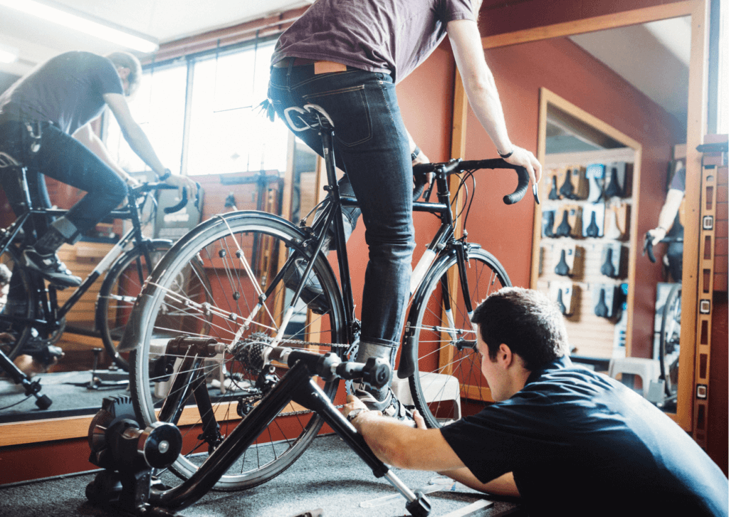 a man getting his bike fitted in a bike shop