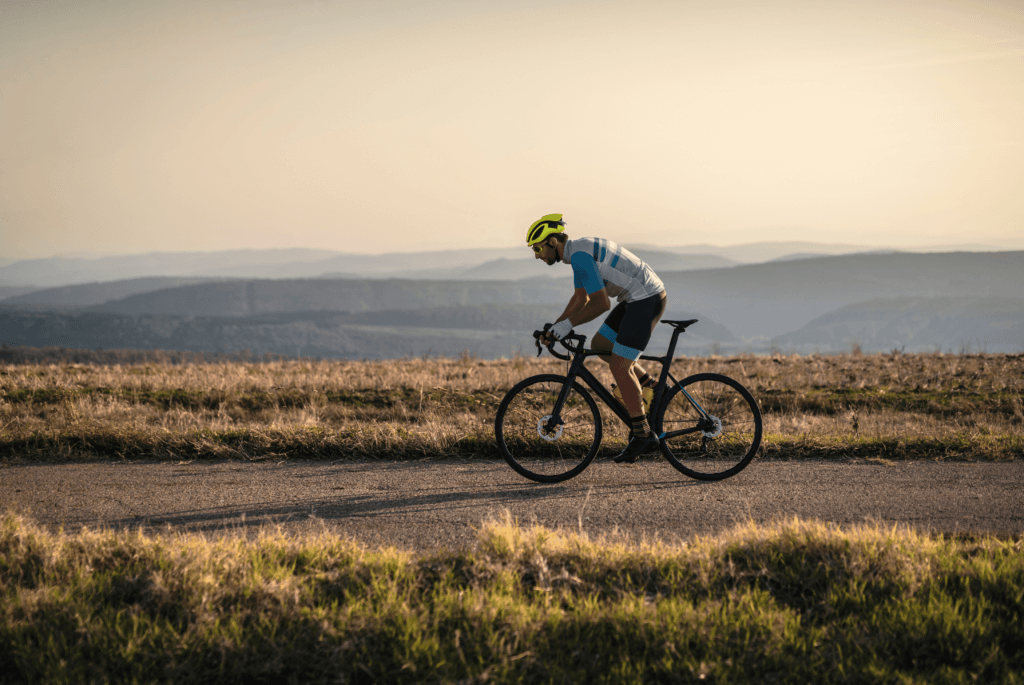 a cyclists sprinting along a road