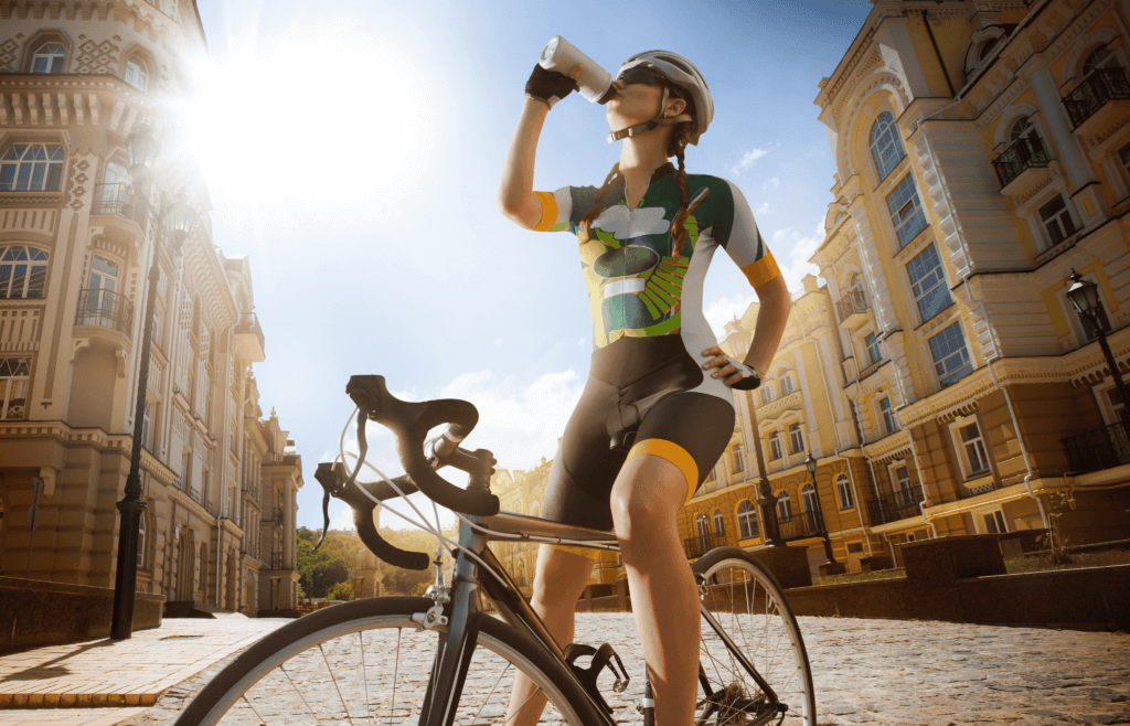 a woman stopped on her road bike, drinking from a bottle