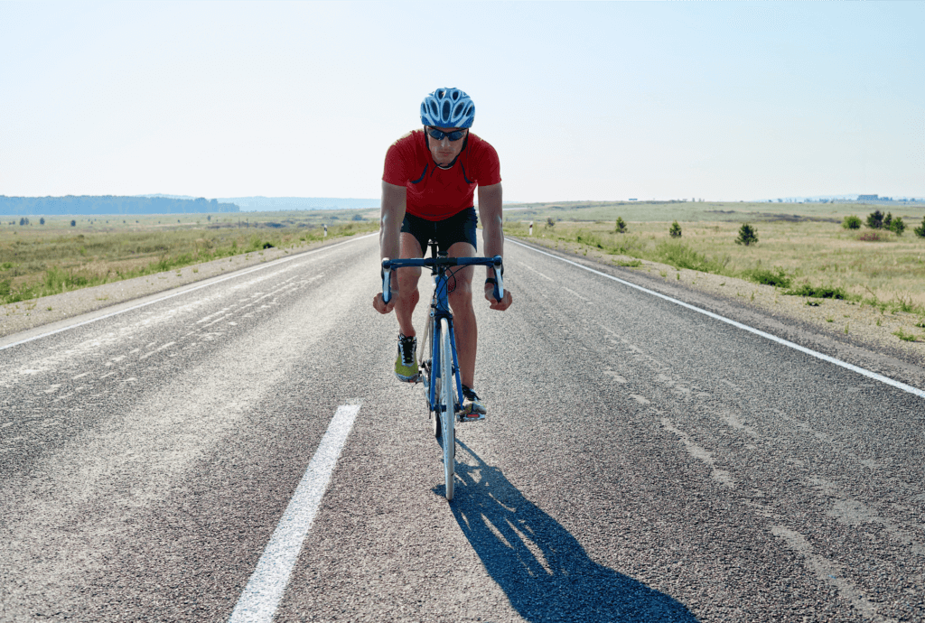a cyclist on an open road 
