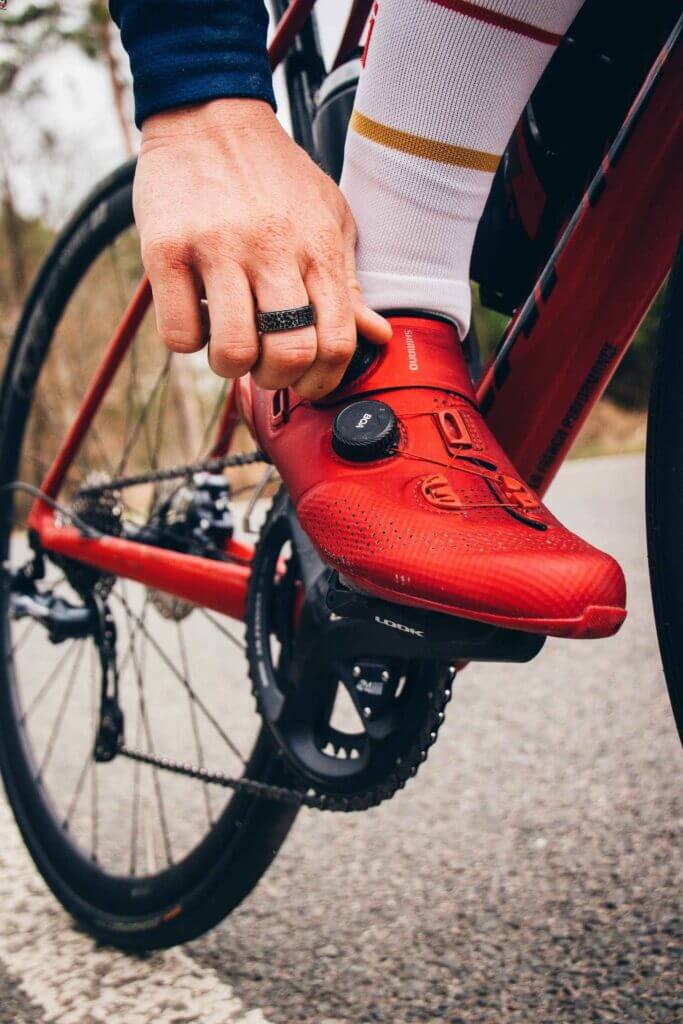 a close up of a cyclists foot, wearing cycling shoes and using clipless pedals