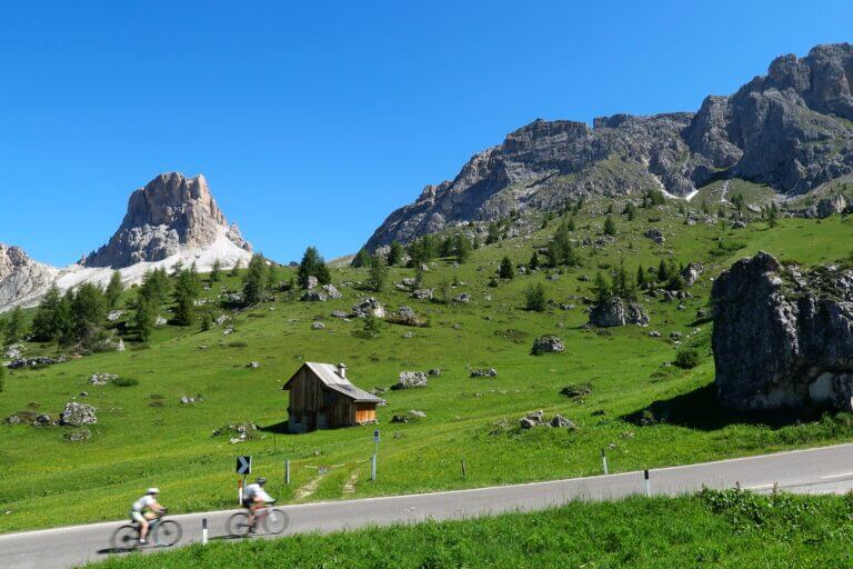 Cyclist going up a hill in the Dolomites in Italy.