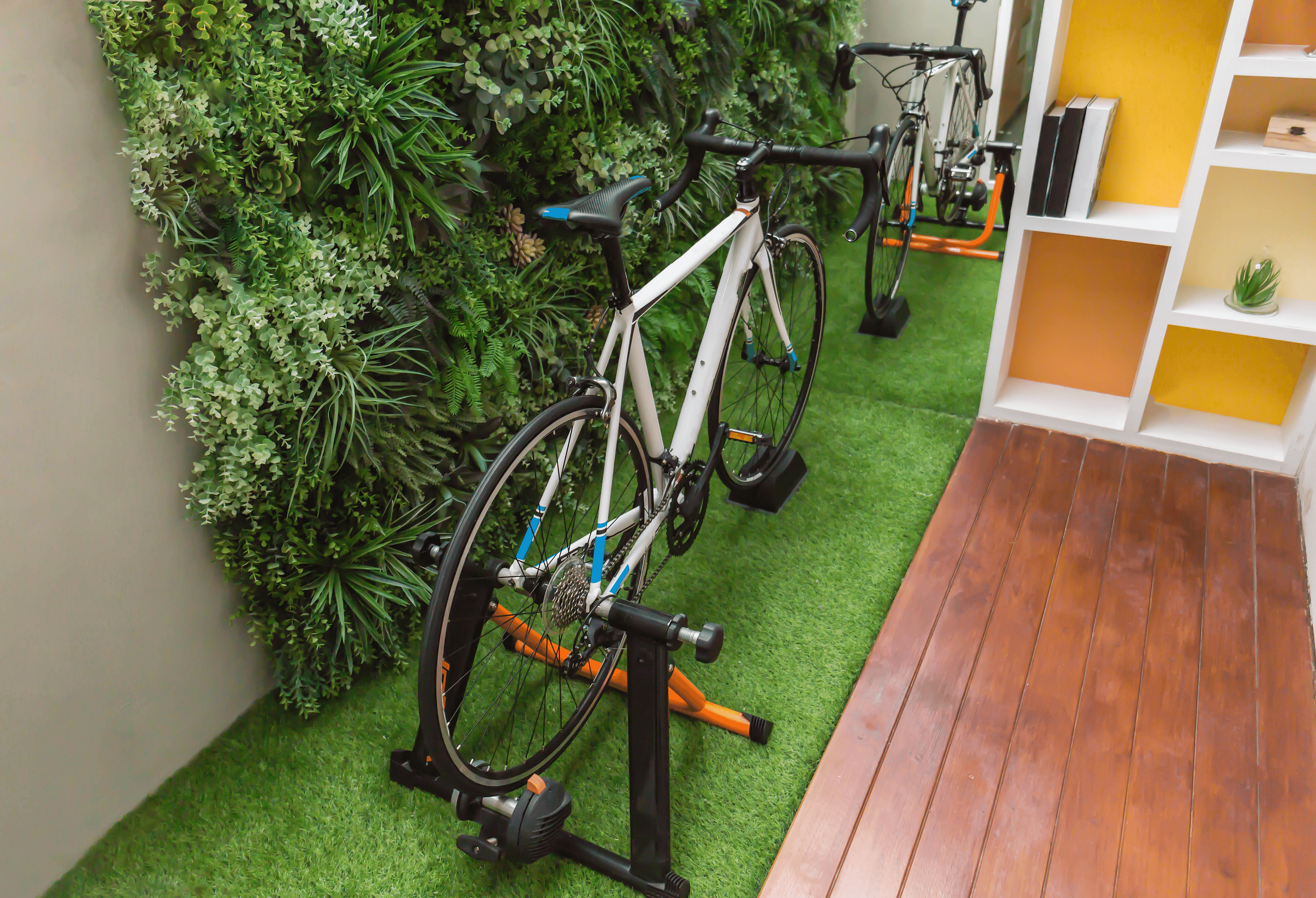 a bike set up on a bike trainer in a garden