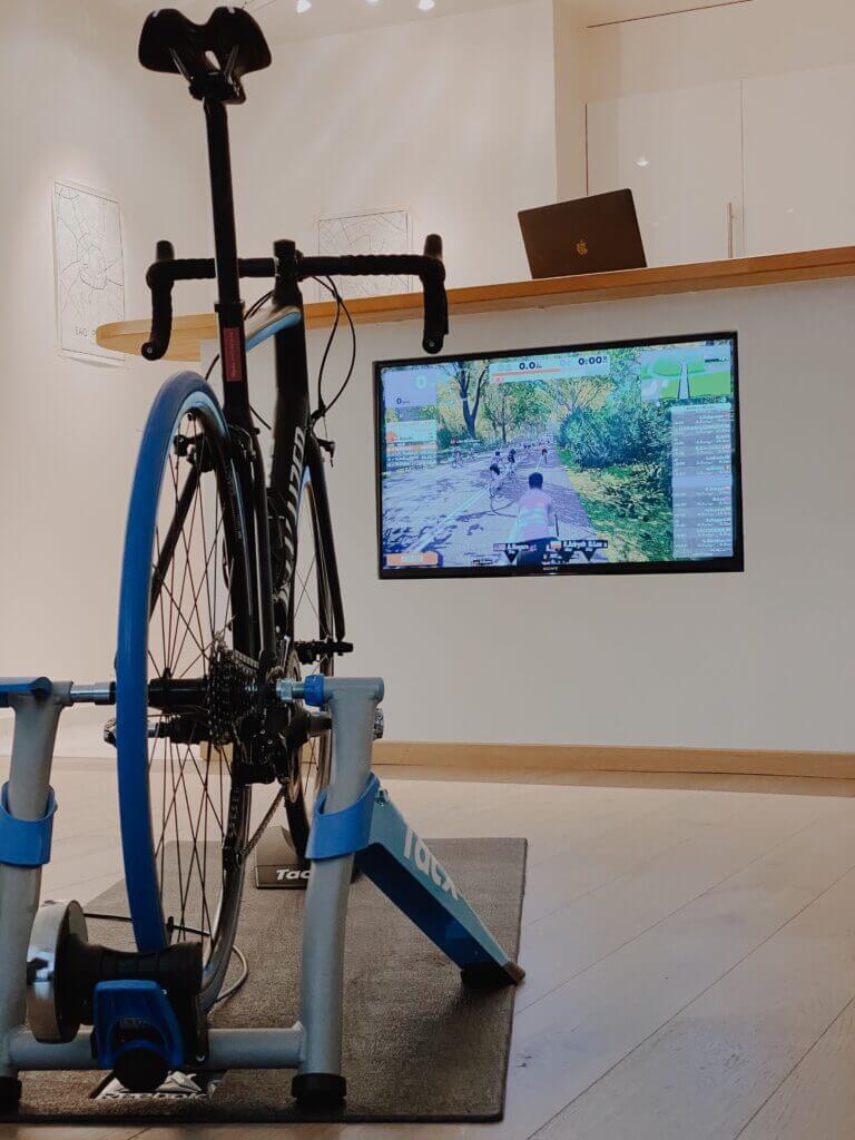 an bike set up on an indoor trainer facing a tv