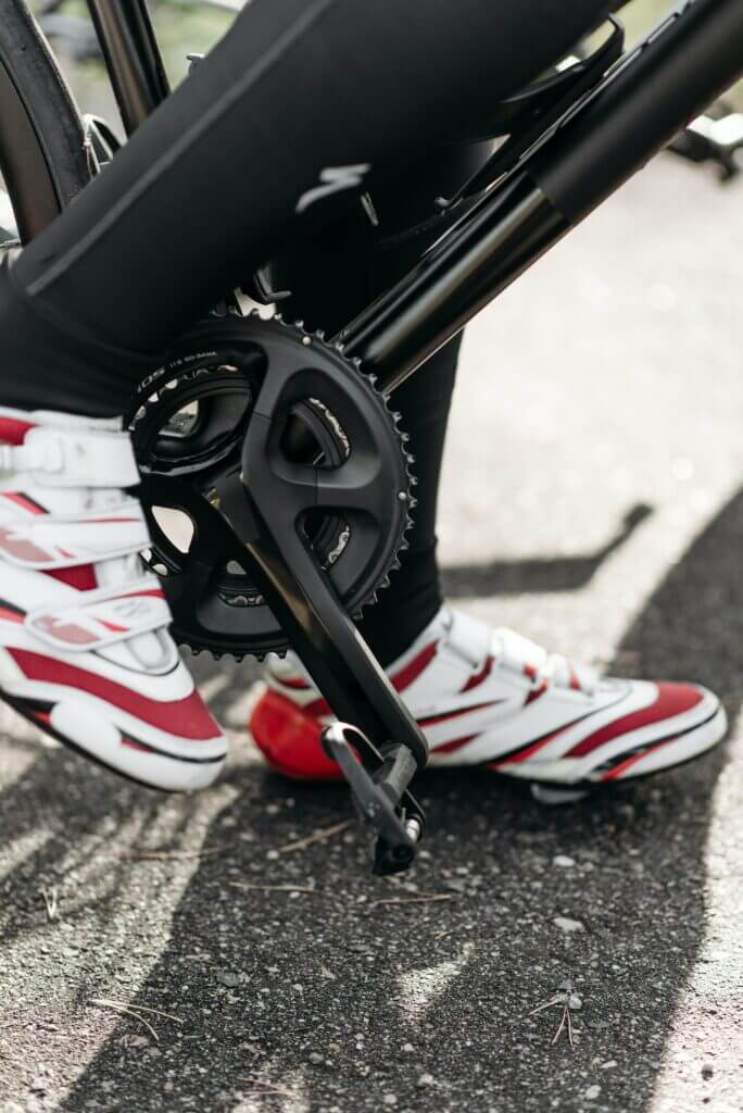 a close up of a cyclists foot, wearing cycling shoes and using clipless pedals