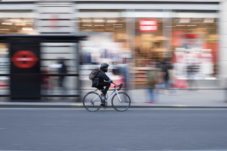 a man cycling a bike through a city street