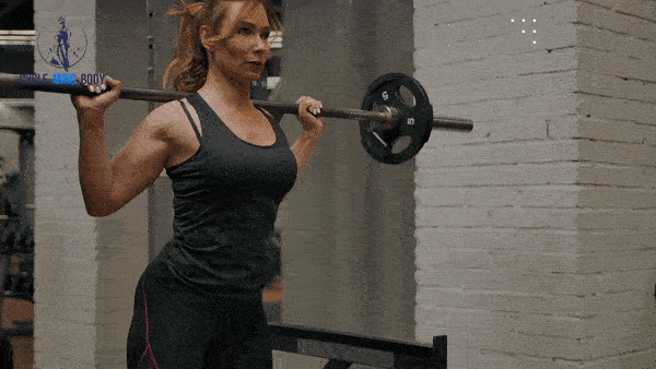 a woman squatting with a barbell with weights