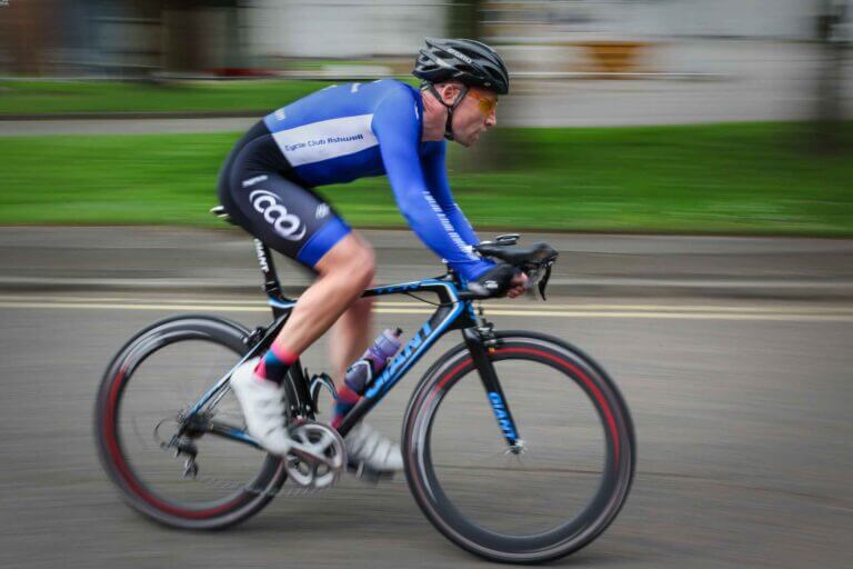 a male cyclist going fast on a road bike