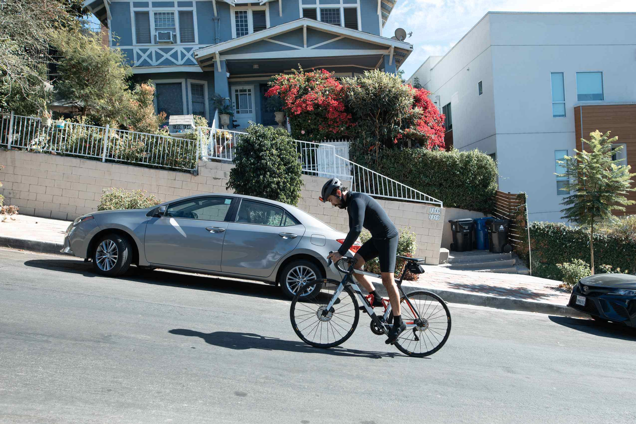a cyclist cycling up a hill climb in an urban area