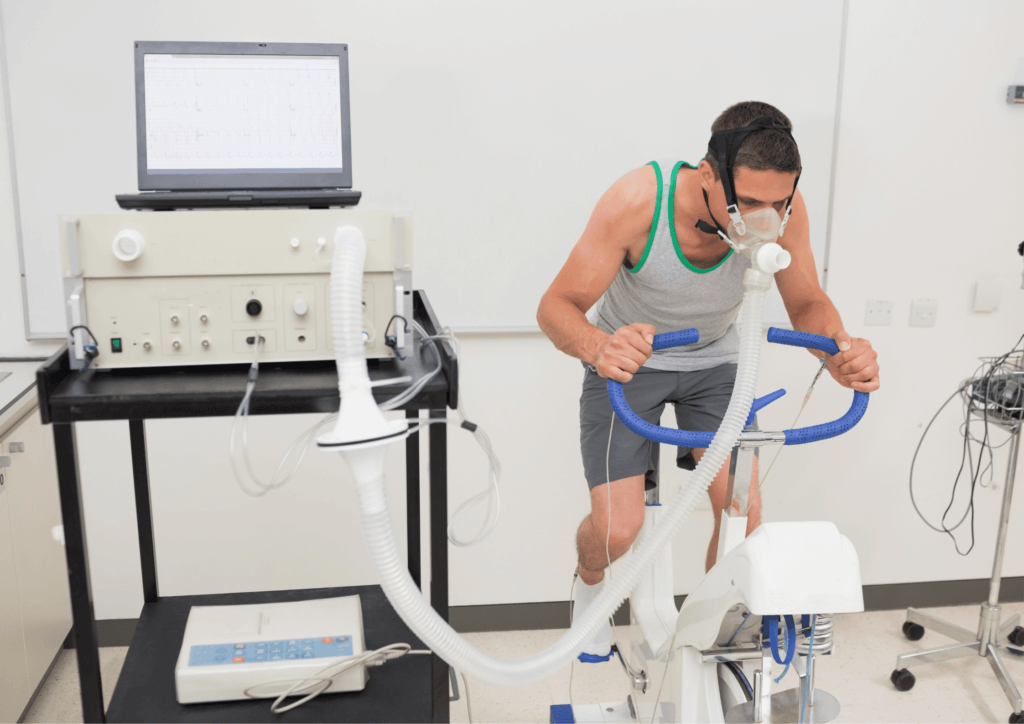 a cyclist performing a test in a lab, attached to equipment