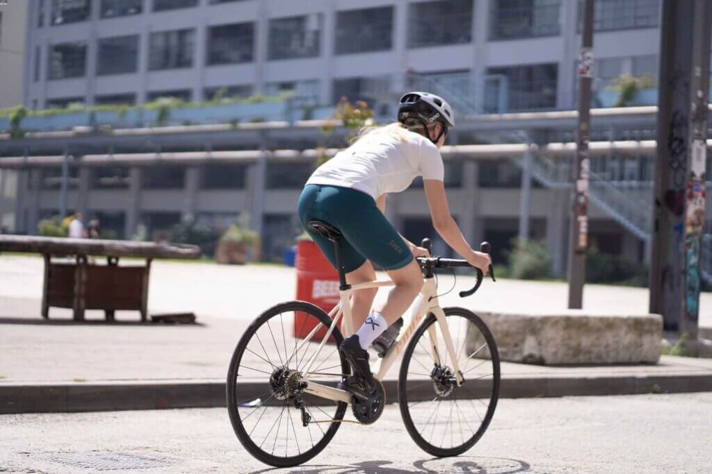 a female cyclist cycling through an urban area