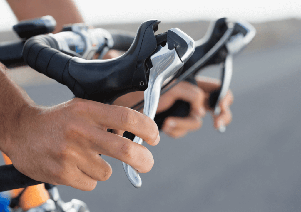 a close up of a road cyclists braking by pressing the brake levers 