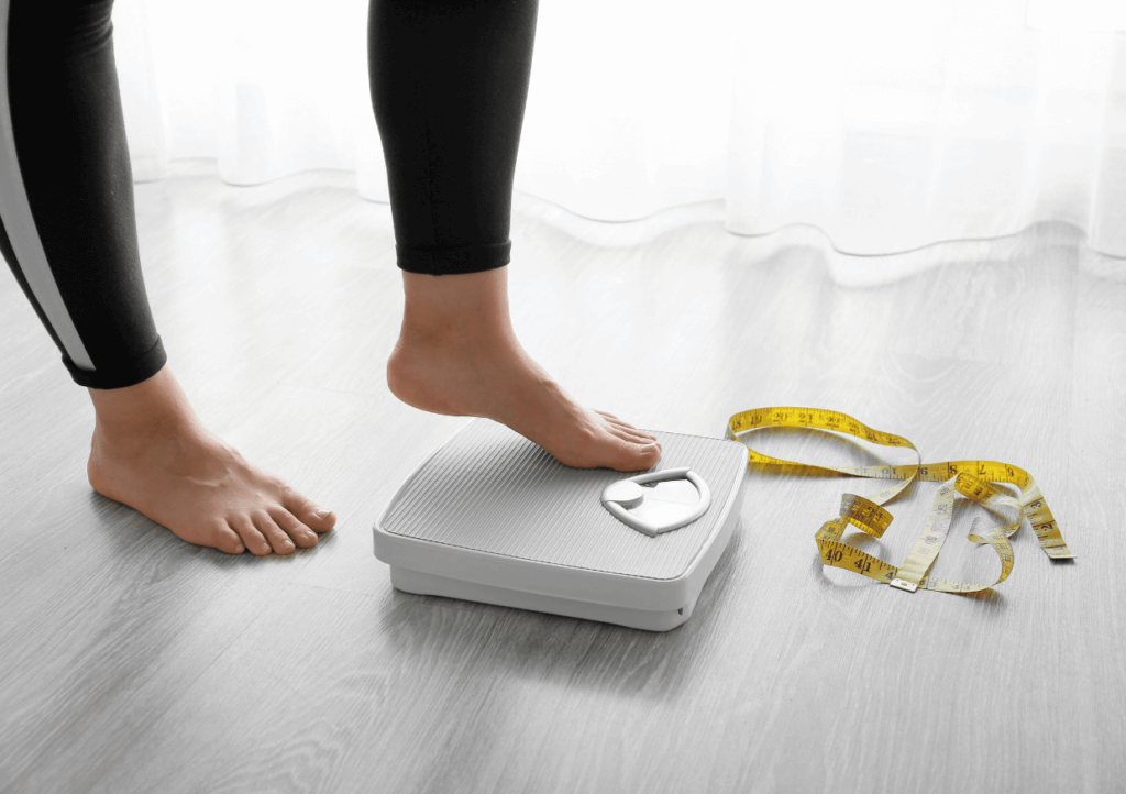 a woman stepping on to a weighing scales