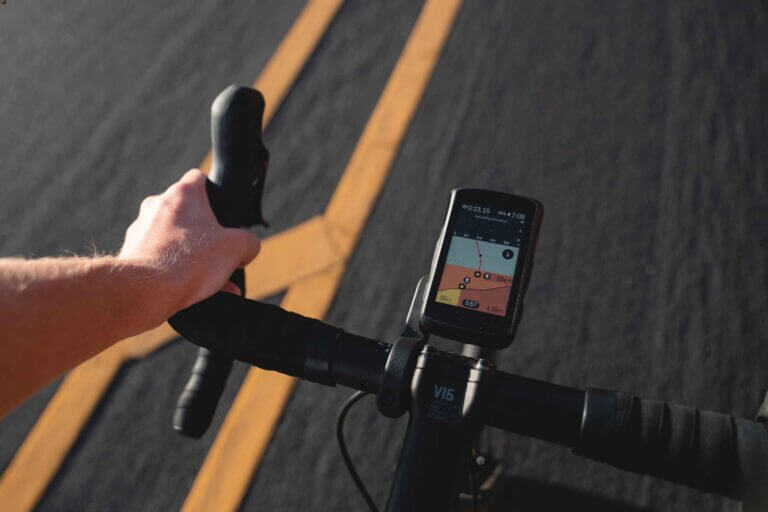 a close up of a road bike handlebars with a bike computer attached