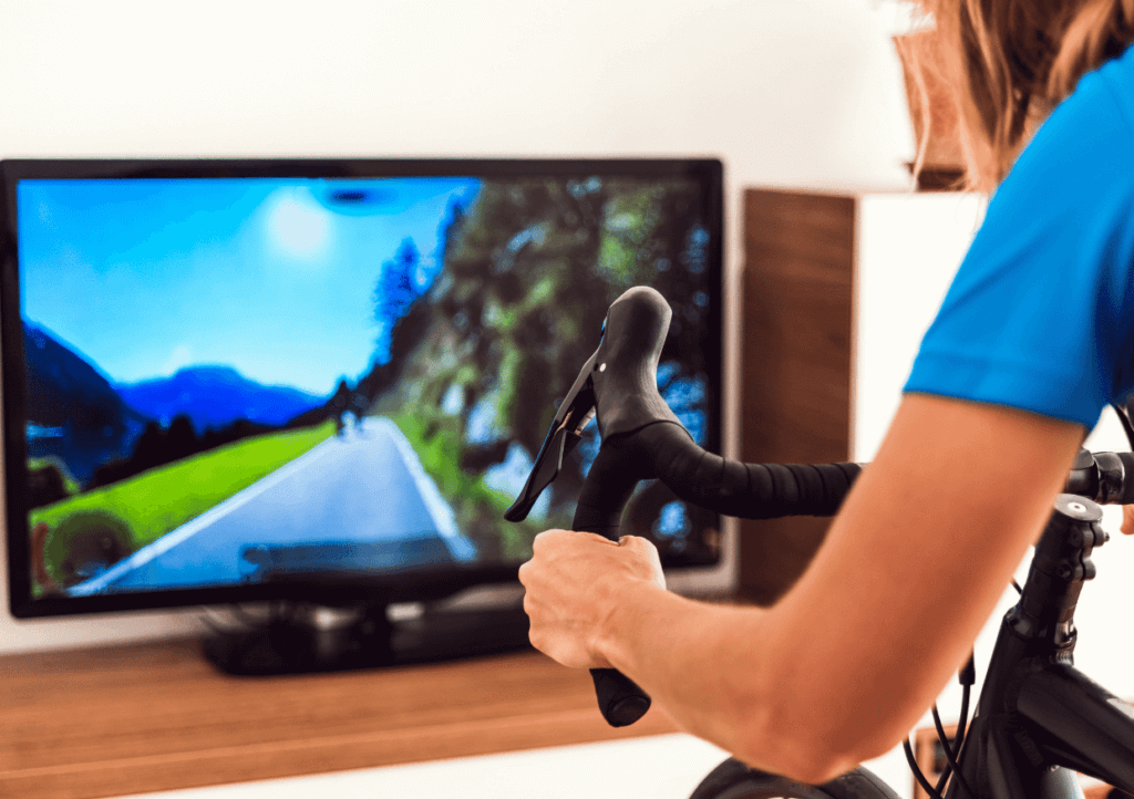 woman on a Smart turbo trainer in front of a tv