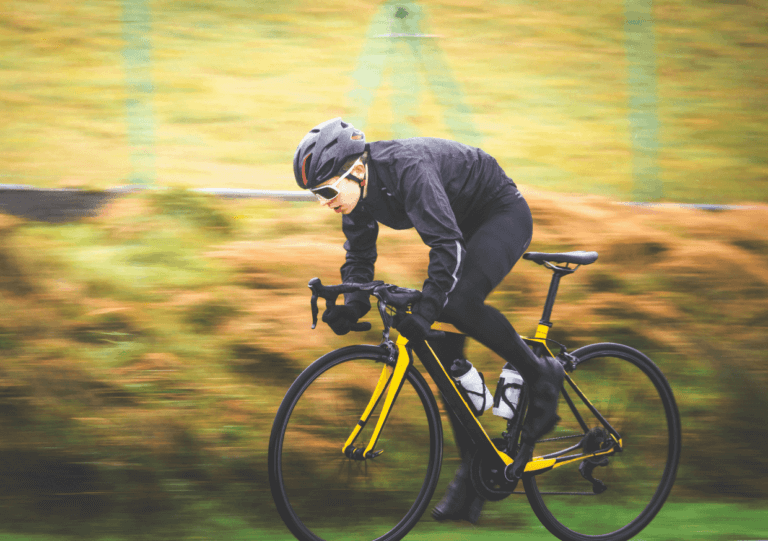 a man sprinting on a road bike