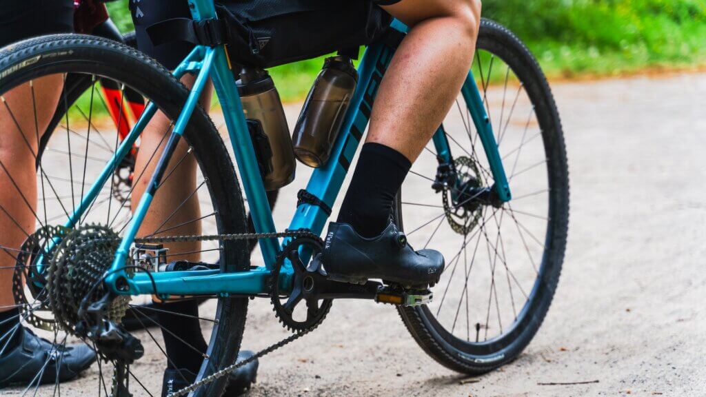 the lower half of cyclist on a gravel bike.