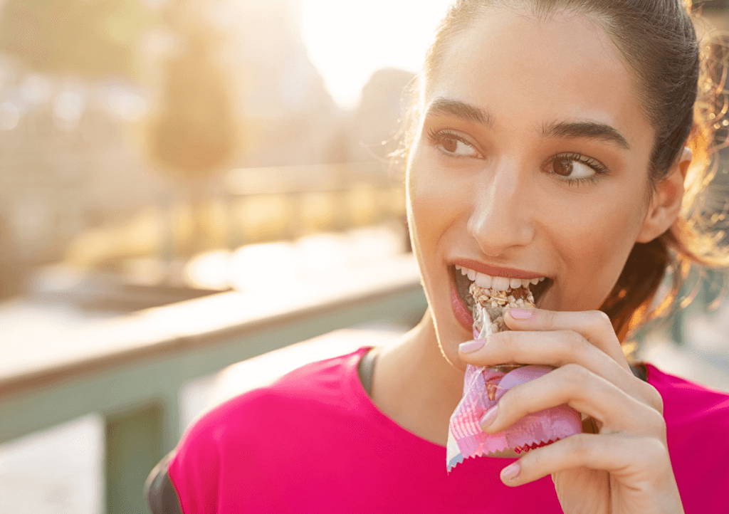 a woman eating an energy bar