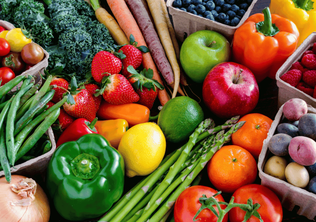 an assortment of raw vegetables and fruit