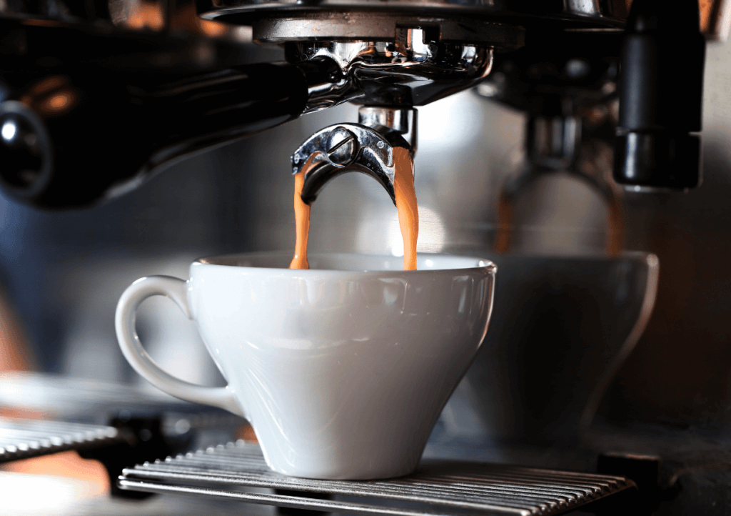 a coffee machine pouring coffee into a cup