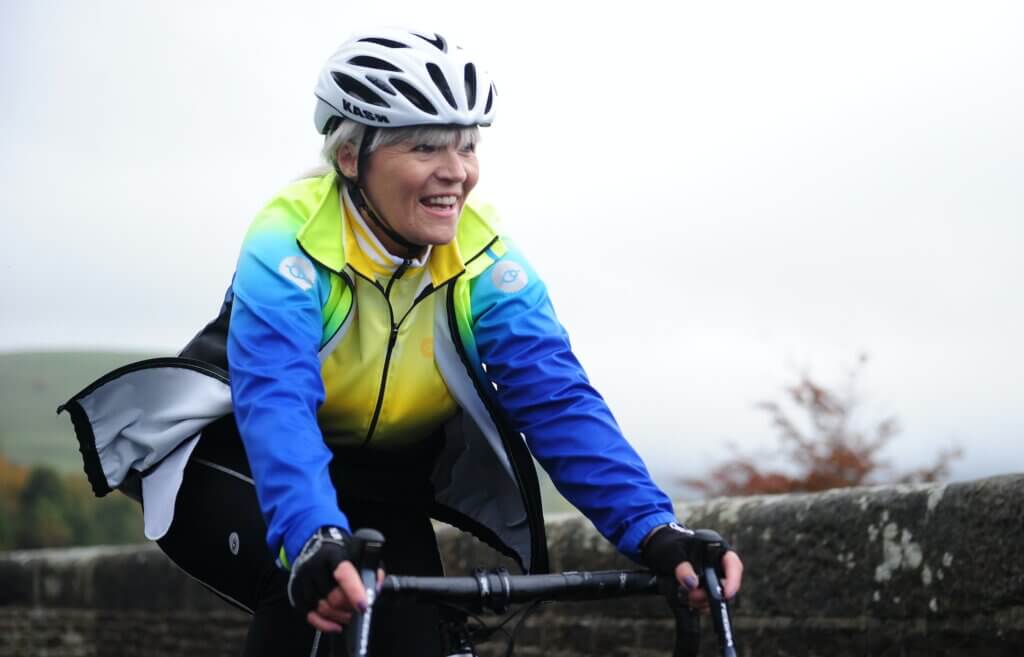 a older woman smiling while cycling