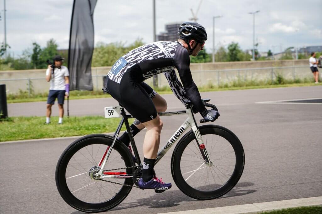 a male cyclist in a race on a aero rad bike and wearing aero clothing